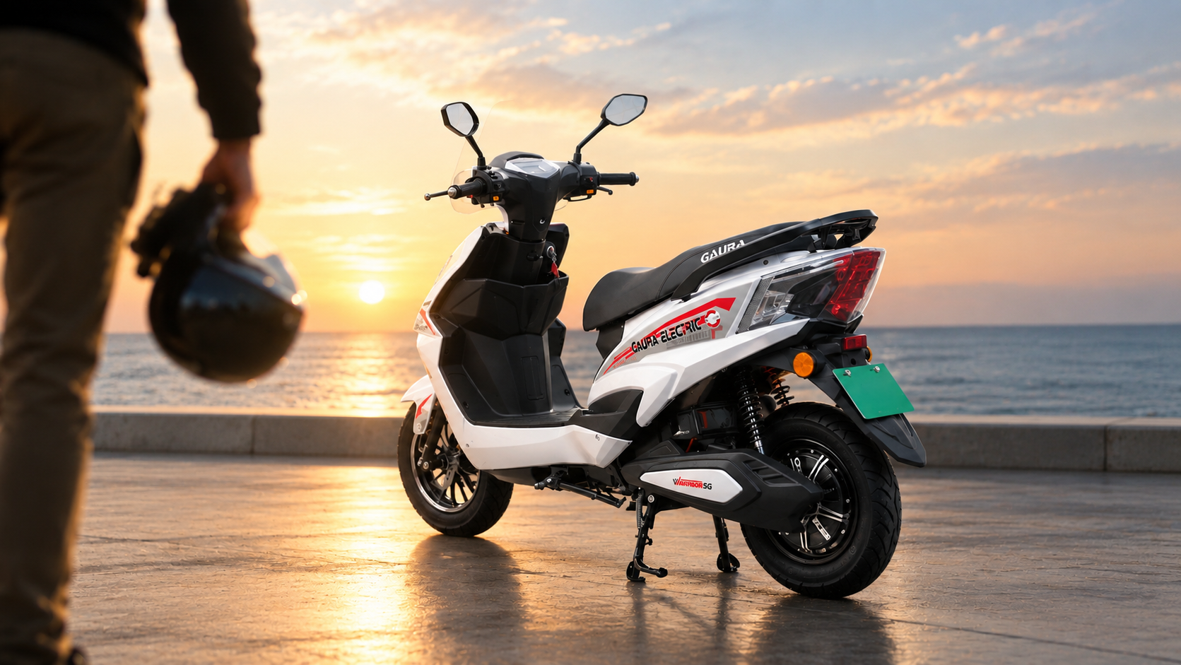 Gaura Warrior 5G in white parked on a seaside promenade at sunset